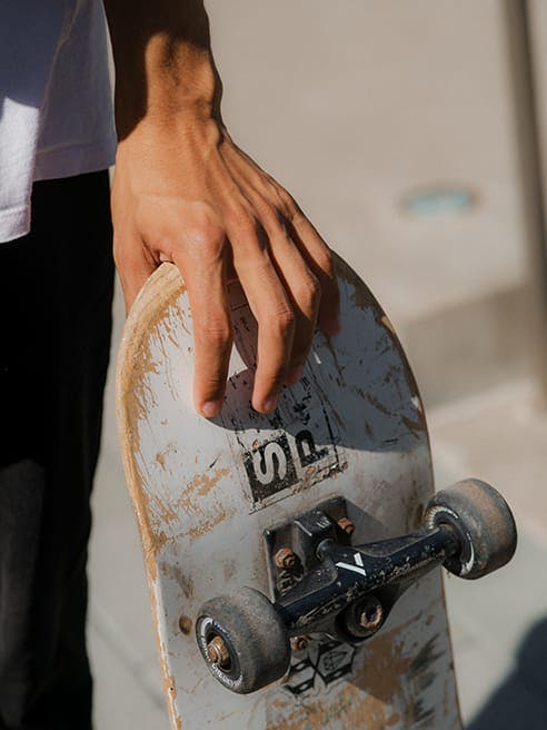 Teen holding skateboard